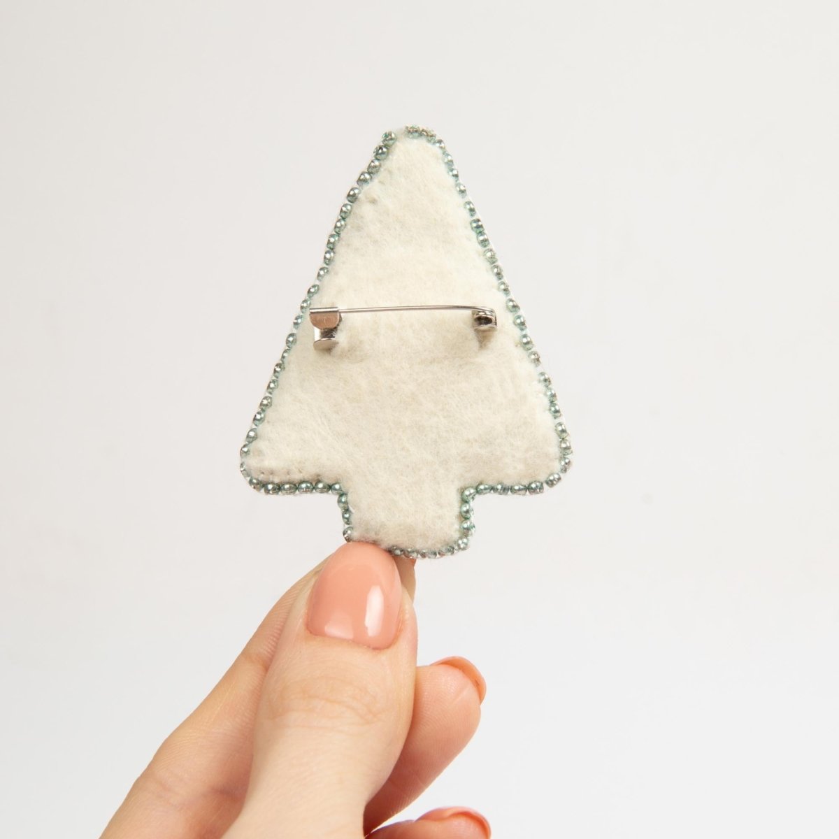 Detailed bead embroidery in progress for the 'Blue Tree' brooch.