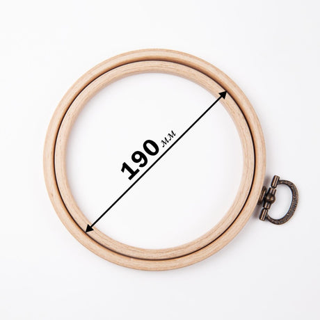 Round beech wood embroidery frame with metal hanger.